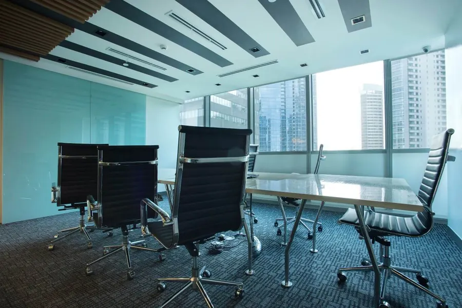 Boardroom with leather chairs and BGC skyline views
