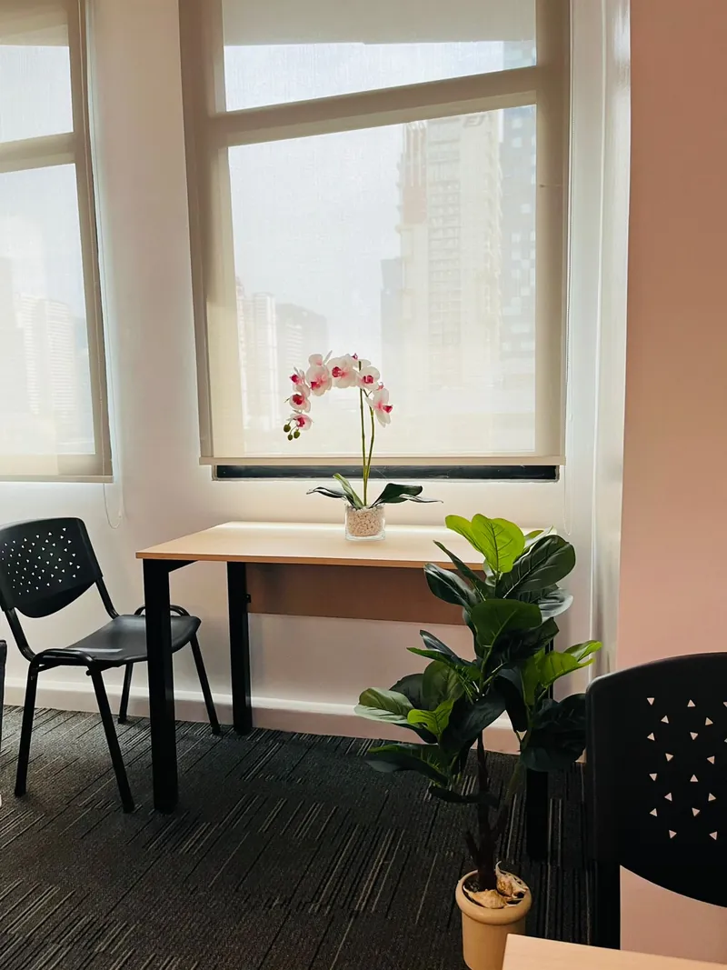 Window-side desk in the vOffice studio with city views